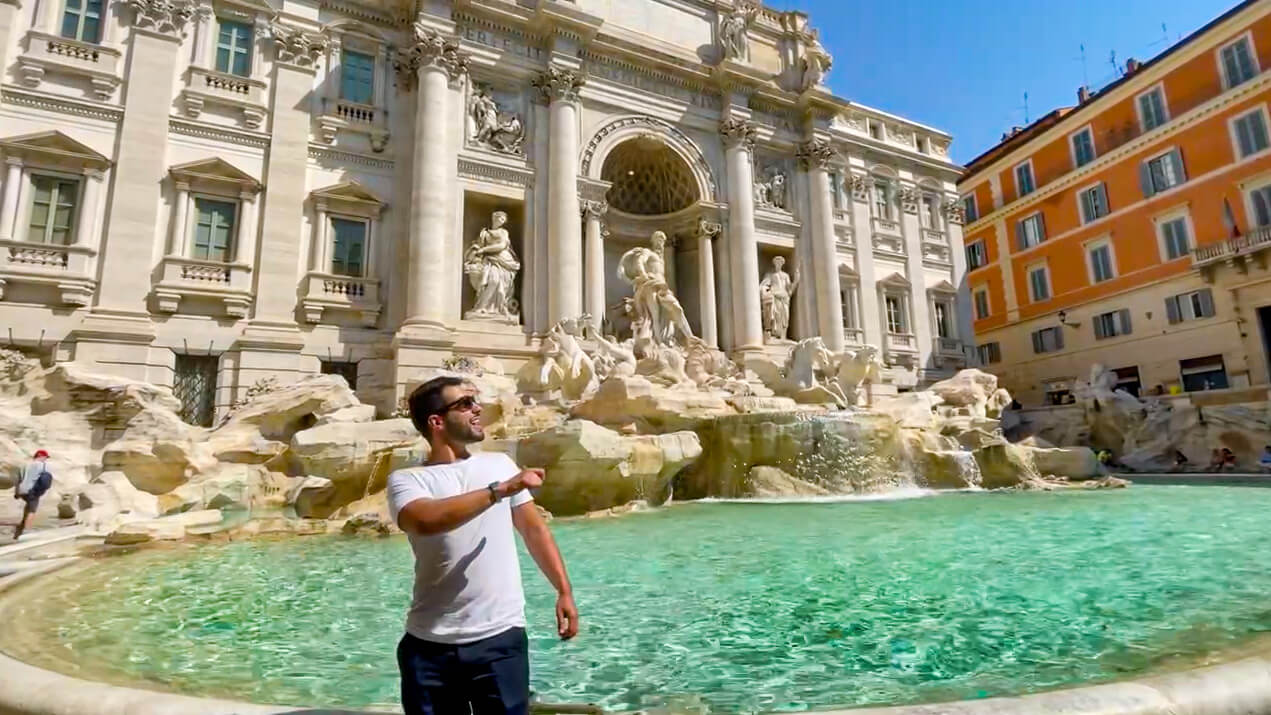 Tossing a coin in Trevi Fountain tradition